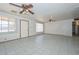 Spacious living room with tile floors, ceiling fans, and bright windows providing natural light at 829 E Echo Ln, Phoenix, AZ 85020