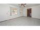 Bright room with tiled floors, ceiling fan, and natural light from two large windows at 829 E Echo Ln, Phoenix, AZ 85020