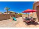 Spacious backyard featuring patio area, play structure, and low-maintenance desert landscaping at 8319 E Portobello Ave, Mesa, AZ 85212
