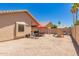 Large backyard featuring desert landscaping, play area, patio, and privacy walls at 8319 E Portobello Ave, Mesa, AZ 85212