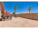 Well-maintained backyard with dining set, play structure, mature trees, and desert landscaping at 8319 E Portobello Ave, Mesa, AZ 85212