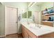 Bathroom features a double sink vanity, mirrors, and linen storage at 8319 E Portobello Ave, Mesa, AZ 85212