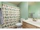Bathroom showcasing a shower with bird-patterned curtain, a vanity, and a sink at 8319 E Portobello Ave, Mesa, AZ 85212