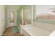 Bright bathroom with tub, glass enclosed shower, and walk-out access at 8319 E Portobello Ave, Mesa, AZ 85212
