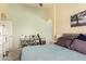 Comfortable bedroom featuring neutral walls, a queen-sized bed, and a storage shelf at 8319 E Portobello Ave, Mesa, AZ 85212