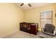 Bedroom featuring a ceiling fan, crib and comfortable rocking chair near a window at 8319 E Portobello Ave, Mesa, AZ 85212