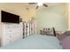 Bright bedroom features a ceiling fan, dresser, media console, and a doorway at 8319 E Portobello Ave, Mesa, AZ 85212