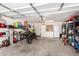 Organized garage with storage shelves, work area, and room for parking a motorcycle at 8319 E Portobello Ave, Mesa, AZ 85212