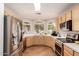 Well-lit kitchen with stainless steel appliances, light wood cabinets, and a bay window above the sink at 8319 E Portobello Ave, Mesa, AZ 85212