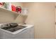 Laundry room features modern washer and dryer with storage shelves above at 8319 E Portobello Ave, Mesa, AZ 85212