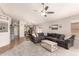 Open-concept living room with neutral paint, carpet, and ceiling fan, seamlessly connecting to the kitchen at 8319 E Portobello Ave, Mesa, AZ 85212