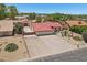Aerial view of a single-story home featuring a red tile roof, three-car garage, and desert landscaping with mature trees at 8511 W Via Montoya Dr, Peoria, AZ 85383