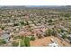 Wide aerial view of suburban neighborhood with tree-lined streets and pools at 8511 W Via Montoya Dr, Peoria, AZ 85383