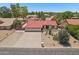 Single-story home with a red tile roof and a spacious three-car garage, surrounded by desert landscaping at 8511 W Via Montoya Dr, Peoria, AZ 85383