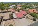 Aerial view of the property shows the main house, separate garage and desert landscaping with mature shade trees at 8511 W Via Montoya Dr, Peoria, AZ 85383