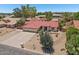 Single-story home showcasing a red tile roof, a three-car garage, and desert landscaping with native cactus at 8511 W Via Montoya Dr, Peoria, AZ 85383