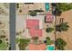 Birds eye view of the home featuring a red roof, air conditioning units, separate garage, desert landscaping, and nearby pools at 8511 W Via Montoya Dr, Peoria, AZ 85383