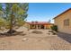 Backyard with a desert landscape, mature trees, and a covered patio at 8511 W Via Montoya Dr, Peoria, AZ 85383