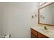 The bathroom features a wood-trimmed mirror, sink, vanity, and attractive fixtures at 8511 W Via Montoya Dr, Peoria, AZ 85383