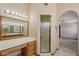 Bathroom showing a shower, vanity, and arched doorway to the main bedroom at 8511 W Via Montoya Dr, Peoria, AZ 85383