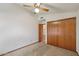 This bedroom boasts neutral carpet and paint, a closet and a ceiling fan for comfort at 8511 W Via Montoya Dr, Peoria, AZ 85383