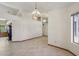 Open dining space features tile flooring and modern lighting fixtures, with views into the kitchen at 8511 W Via Montoya Dr, Peoria, AZ 85383