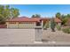 Charming single-story home with a red tile roof and three-car garage in a well-manicured desert landscape at 8511 W Via Montoya Dr, Peoria, AZ 85383