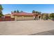 Well-maintained home featuring a red tile roof, three-car garage, and low-maintenance desert landscaping at 8511 W Via Montoya Dr, Peoria, AZ 85383