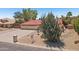 Charming single-story home featuring a red tile roof, three-car garage, and desert landscaping with a large cactus at 8511 W Via Montoya Dr, Peoria, AZ 85383