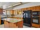 Updated kitchen featuring wood cabinets, granite countertops, and sleek black appliances at 8511 W Via Montoya Dr, Peoria, AZ 85383