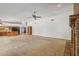 Open concept living space features a brick fireplace and seamless flow into the adjacent kitchen at 8511 W Via Montoya Dr, Peoria, AZ 85383