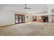 Bright living area combines carpet and tile flooring with a view of the kitchen and outdoor access at 8511 W Via Montoya Dr, Peoria, AZ 85383