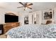 Bright bedroom shows a wood dresser, a TV, and a king bed with light-colored walls at 942 S Deerfield Ln, Gilbert, AZ 85296