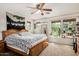 Bright bedroom features a ceiling fan, light neutral walls, and a window seat with a great view and lots of plants at 942 S Deerfield Ln, Gilbert, AZ 85296