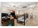 Spacious bonus room with modern decor, a ceiling fan, and natural light from the windows at 942 S Deerfield Ln, Gilbert, AZ 85296