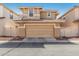 Home exterior showcasing a two car garage, beige stucco, and a well maintained concrete driveway at 942 S Deerfield Ln, Gilbert, AZ 85296