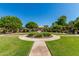 Community green space featuring walking paths, seating, lush landscaping, and well-maintained grounds at 942 S Deerfield Ln, Gilbert, AZ 85296