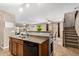 Kitchen with a view of the living room, carpet, tile flooring, a staircase and dining area at 942 S Deerfield Ln, Gilbert, AZ 85296