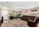 Bright living room with a large sectional sofa, an aquarium, and a decorative map on the wall at 942 S Deerfield Ln, Gilbert, AZ 85296