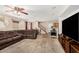 Spacious living room with carpet flooring, ceiling fan, and a comfortable sectional sofa at 942 S Deerfield Ln, Gilbert, AZ 85296