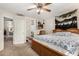 Bright main bedroom with wood frame bed, ensuite bathroom, and a wall decoration of a horse painting at 942 S Deerfield Ln, Gilbert, AZ 85296