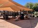 Community playground offering swings, slides, and climbing structures, covered by shade canopies at 942 S Deerfield Ln, Gilbert, AZ 85296