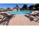 Community pool with lounge chairs and clear blue water on a sunny day at 942 S Deerfield Ln, Gilbert, AZ 85296
