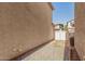 Property side yard with neutral stucco walls, gravel landscaping, and a white wooden fence at 942 S Deerfield Ln, Gilbert, AZ 85296