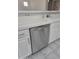 A modern stainless steel dishwasher is set between white cabinets and white tile countertops at 955 W Laurel Ave, Gilbert, AZ 85233
