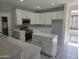 Spacious kitchen with white cabinetry, tiled countertops, stainless steel appliances, and large island at 955 W Laurel Ave, Gilbert, AZ 85233