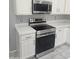 Modern kitchen appliances including stainless steel oven and microwave, and white tile countertops at 955 W Laurel Ave, Gilbert, AZ 85233