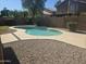 Backyard featuring a sparkling private pool surrounded by desert landscaping at 955 W Laurel Ave, Gilbert, AZ 85233