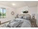 Bedroom area featuring decorated queen bed, window, and soft natural lighting at 10610 S 48 St # 1068, Phoenix, AZ 85044