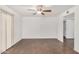 Spacious living room featuring wood-look floors, a ceiling fan, and sliding glass doors at 10610 S 48 St # 1068, Phoenix, AZ 85044